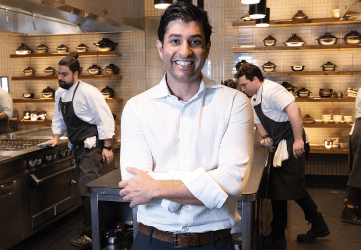 Akeel Shah with white shirt arms crossed in restaurant kitchen