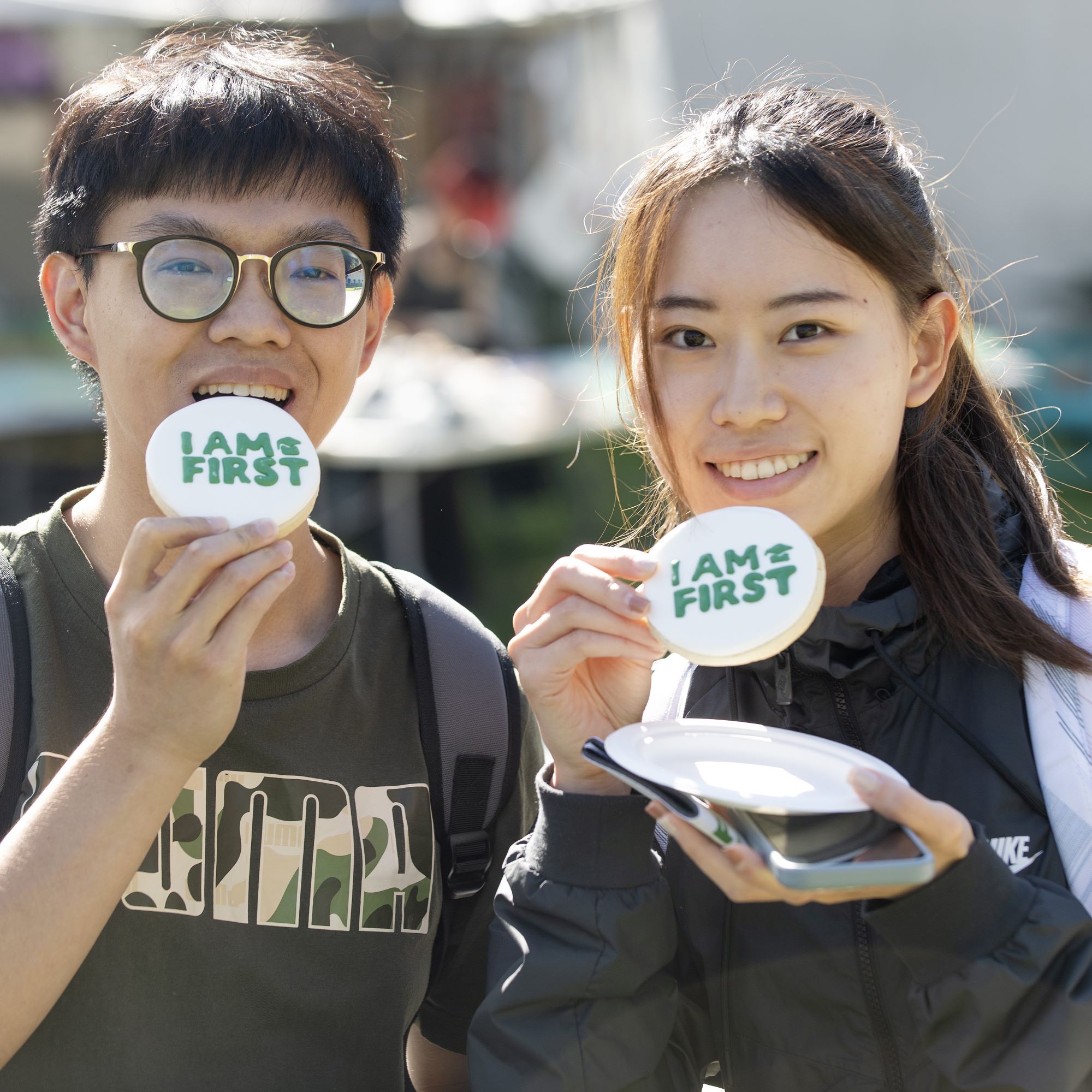 Two students hold CPP swag