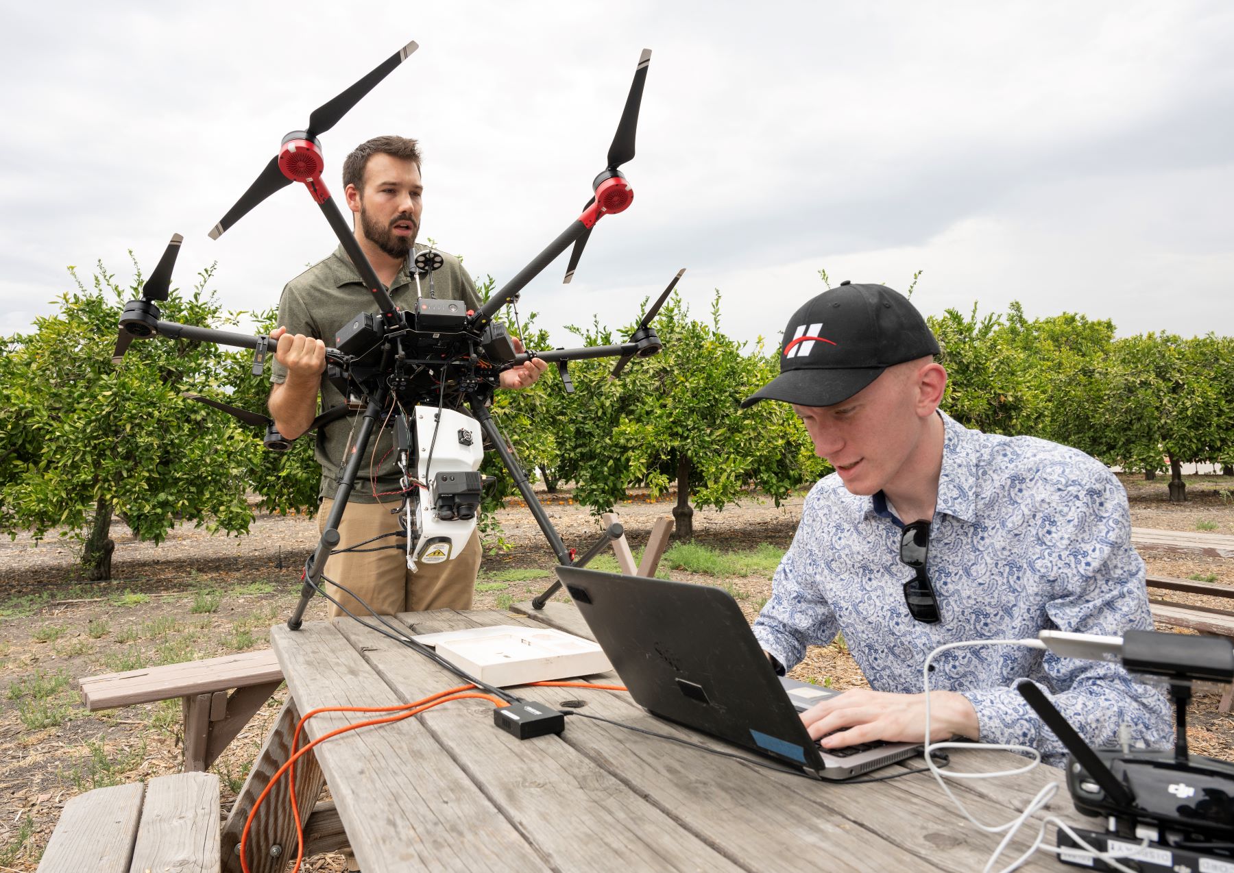 Two students work on a drone