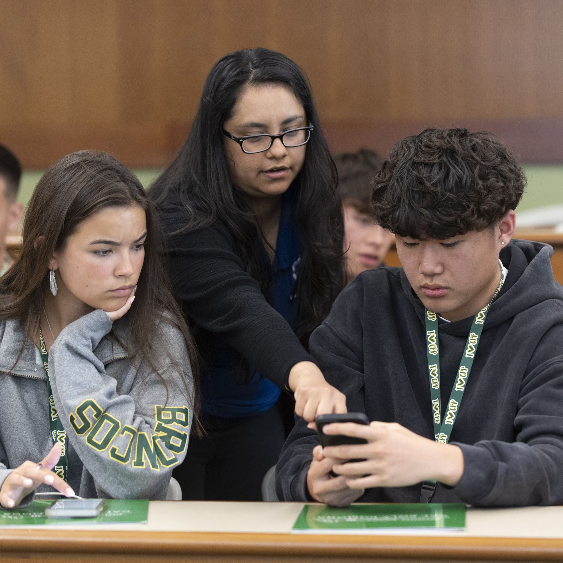 Advisor speaks with a female and male student during orientation