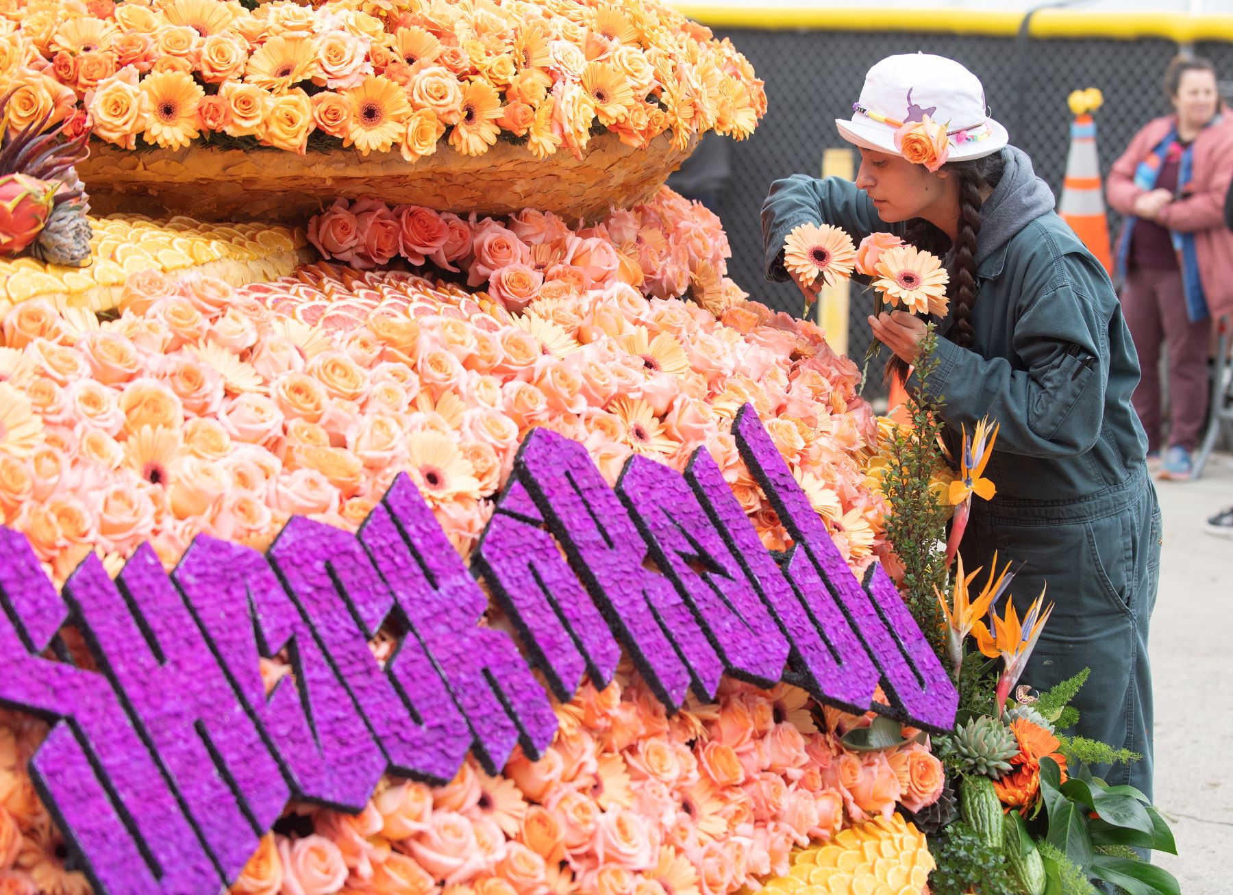 Student places roses on the float during Deco Week.