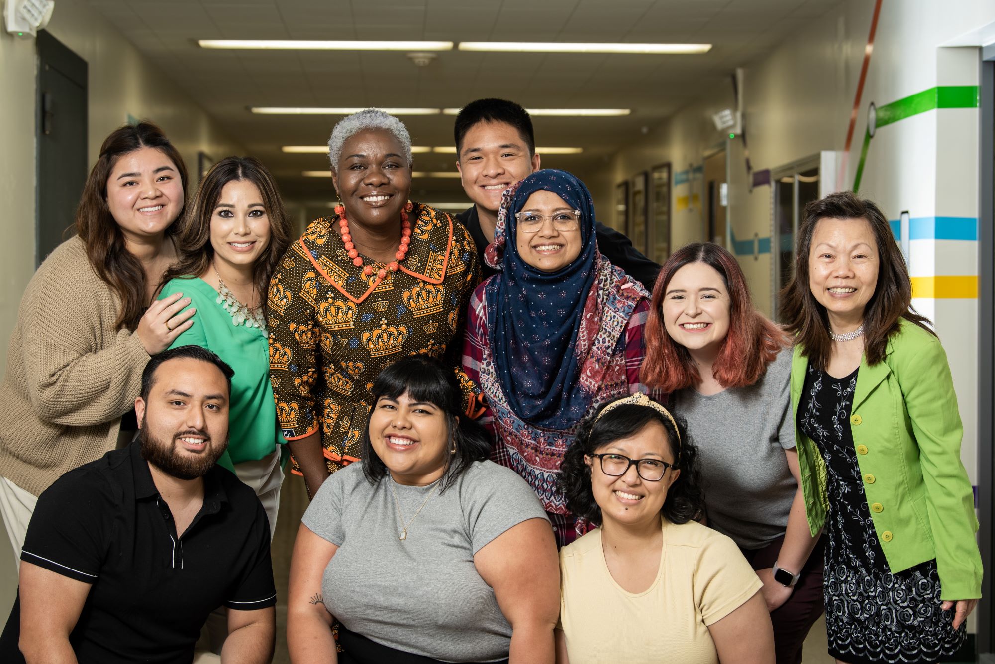 A group of faculty and staff members smile for a group photo