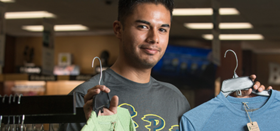 Student holding clothing