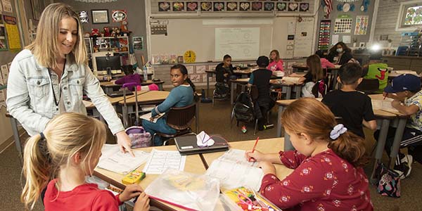 credential student working in a classroom with kids