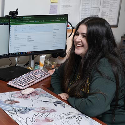 advisor sitting at desk on computer