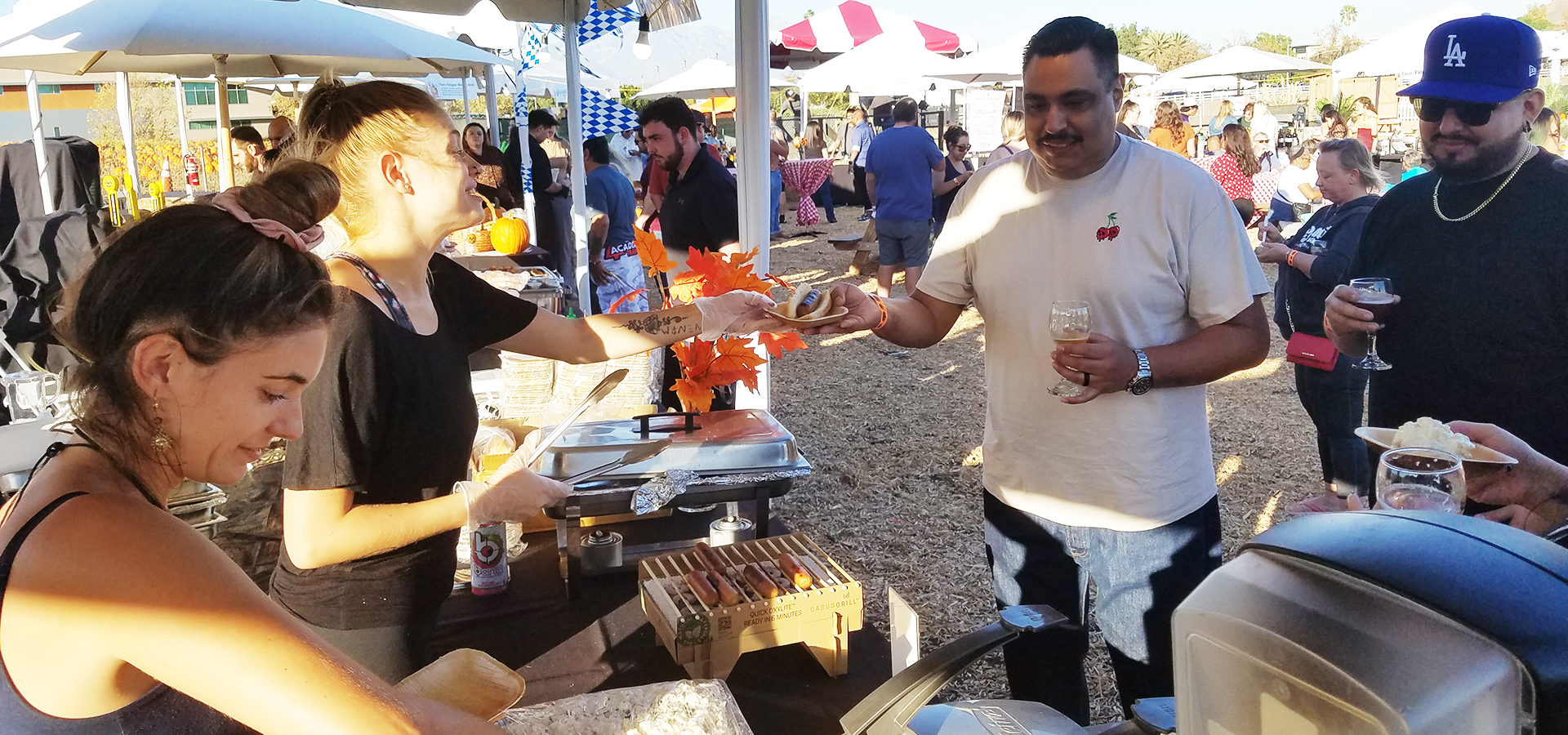 A server hands a customer a bratwurst