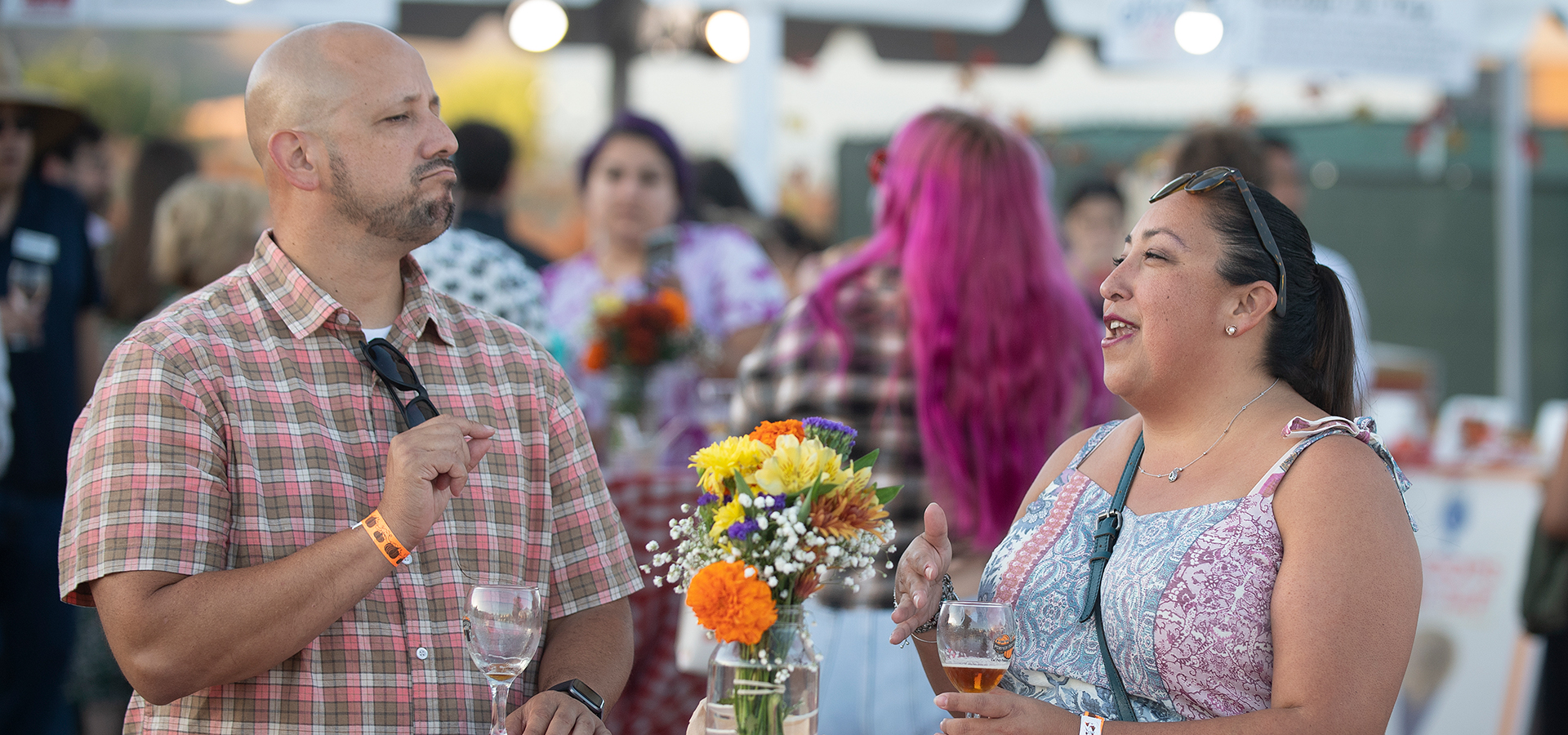 A man and a woman in conversation at one of the tables. 