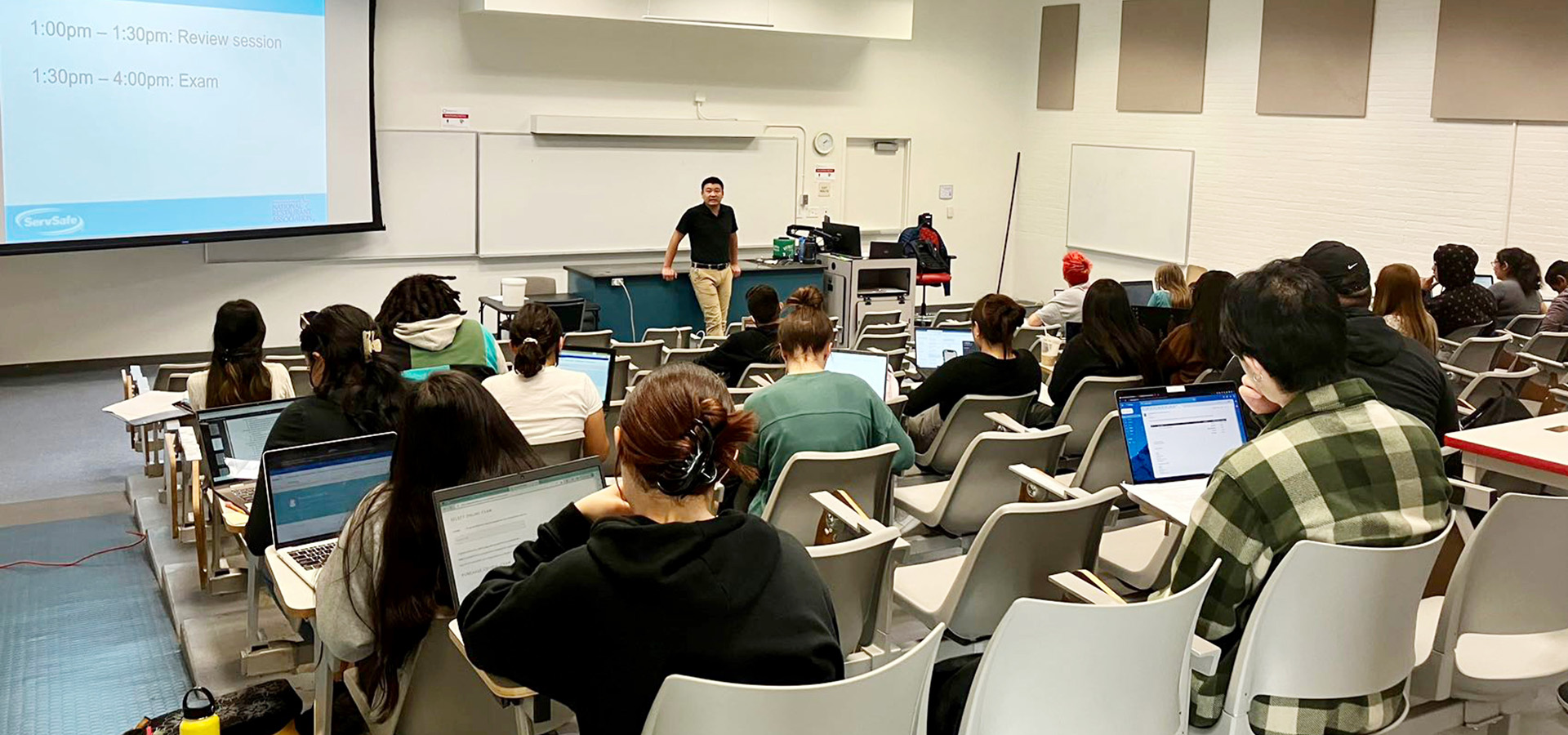 Students listen to an instructor at a ServeSafe workshop