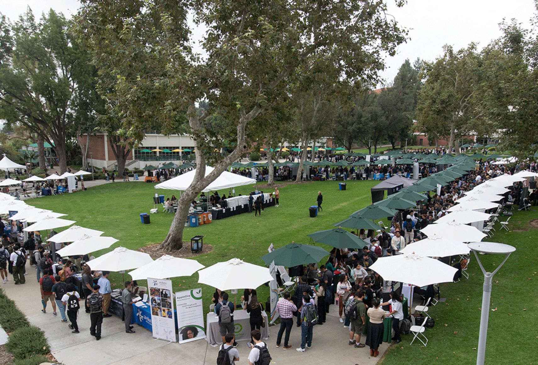 Aerial view of the career fair showing students crowded around company booths.