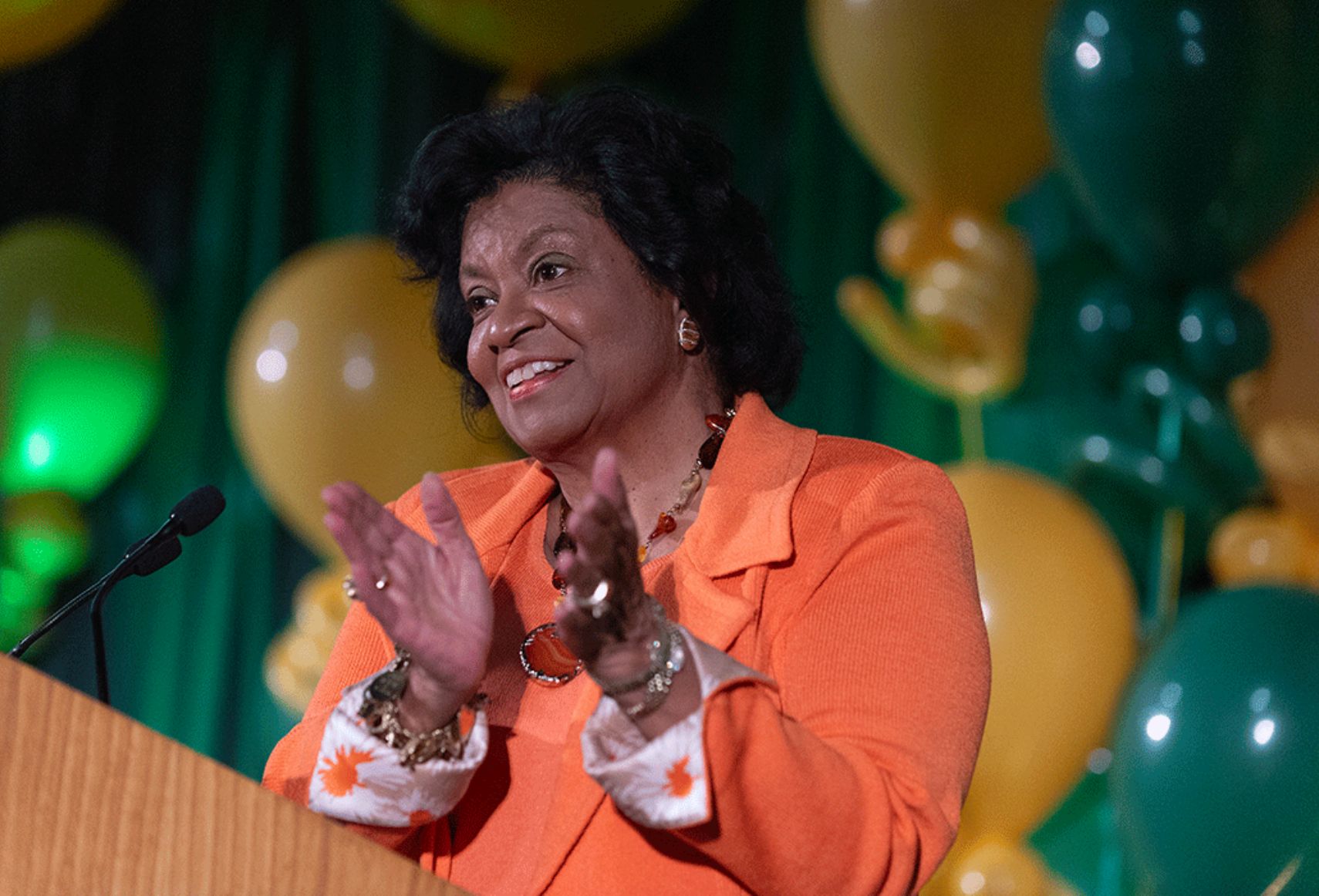 soraya m coley smiling at podium.