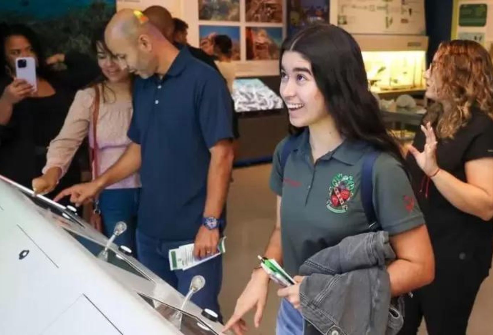 Group of students from Inter American University of Puerto Rico Barranquitas Campus interacting with STEM exhibit