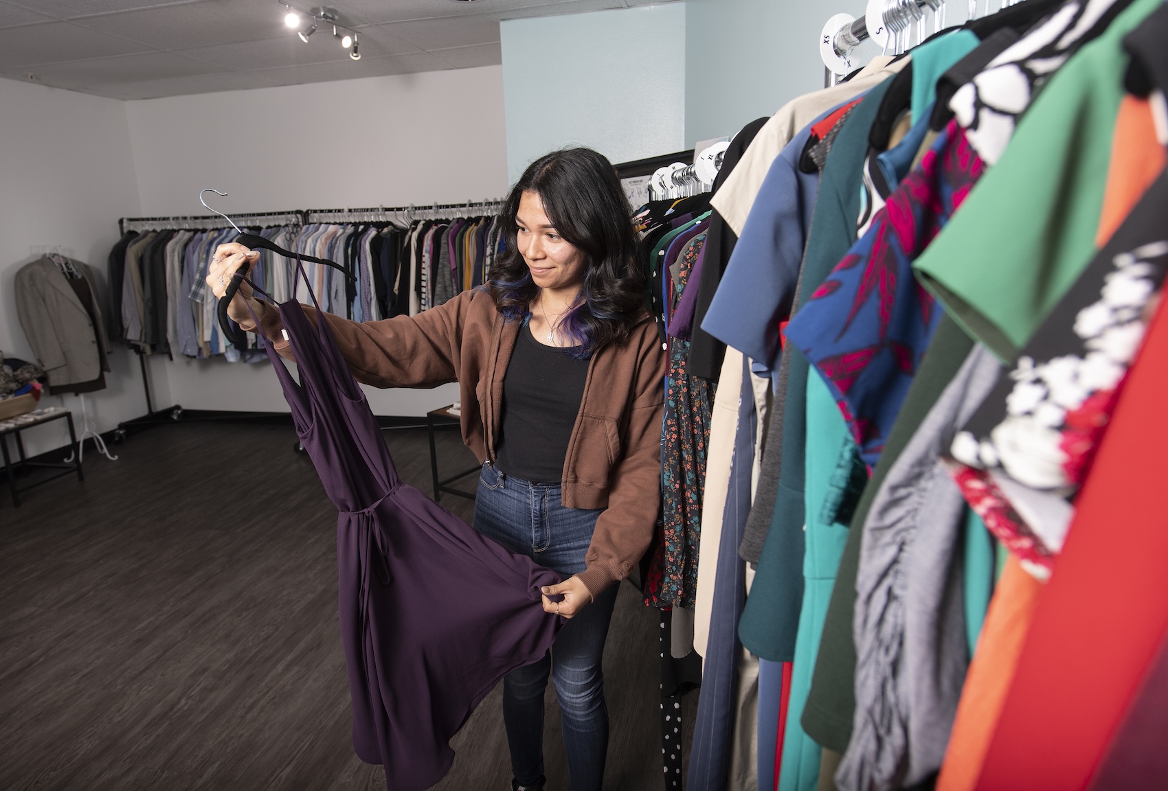 A student looks through the options at the Clothes Closet