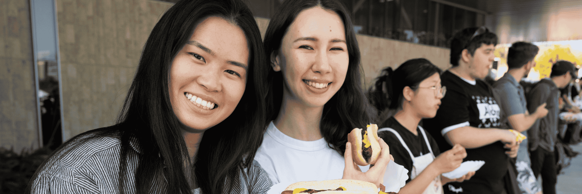 Students pose with their free hot dogs at the Caper