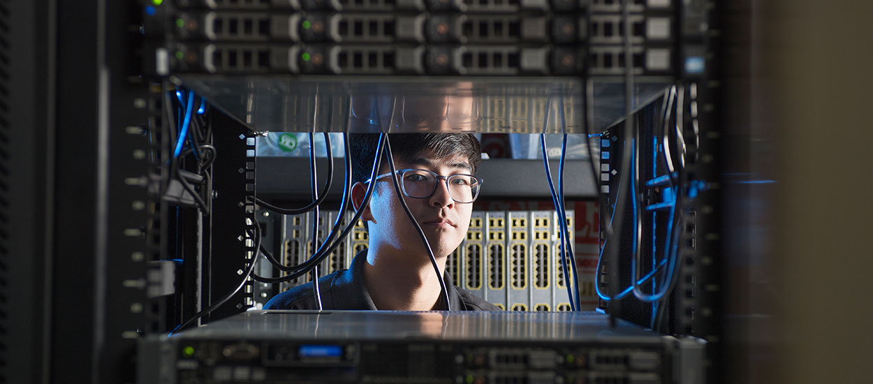 Cybersecurity student in lab working on computers