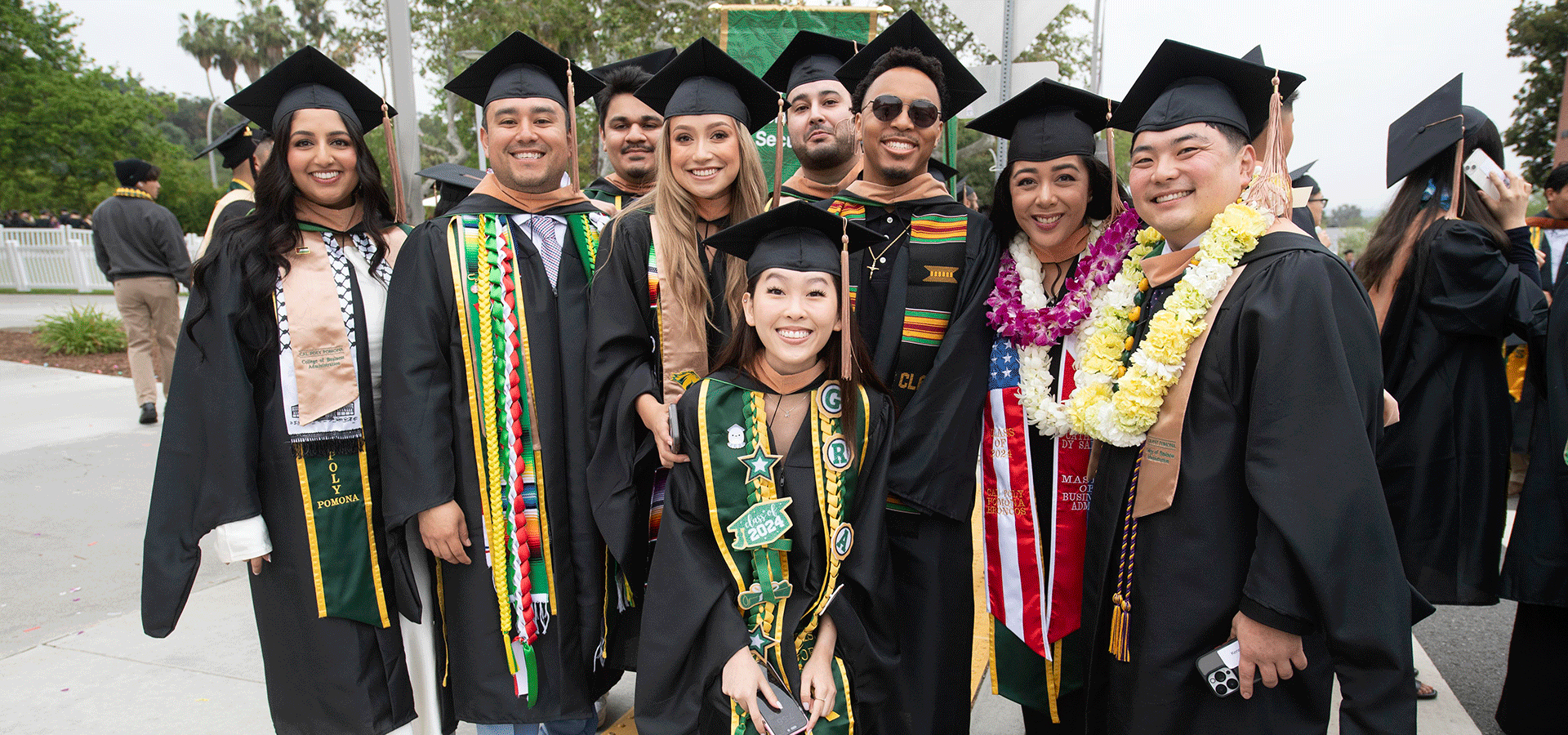 A group of College of Business Graduates pose for a photo.