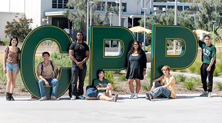 Group of students pose by the CPP letters at the Park at 98
