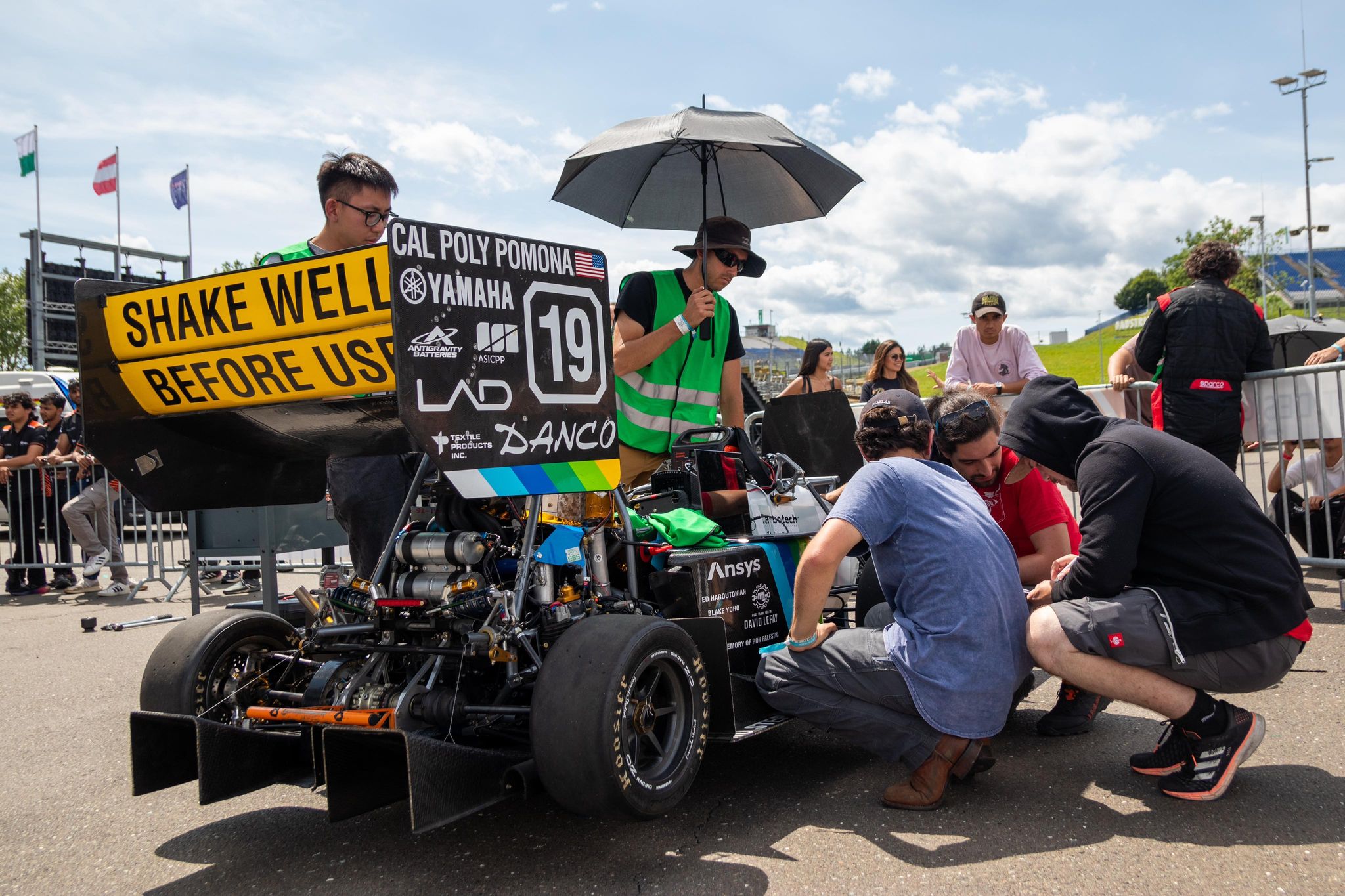 The Cal Poly Pomona FSAE team and their race car in FS competition.