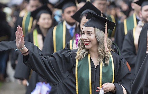 CPP Graduate Smiling and Waving