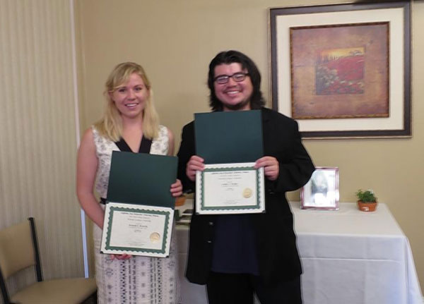 Hannah and Emilio pose with their scholarship awards