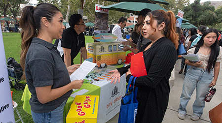 Students stop at a booth for Bay Cities Packaging and Design.