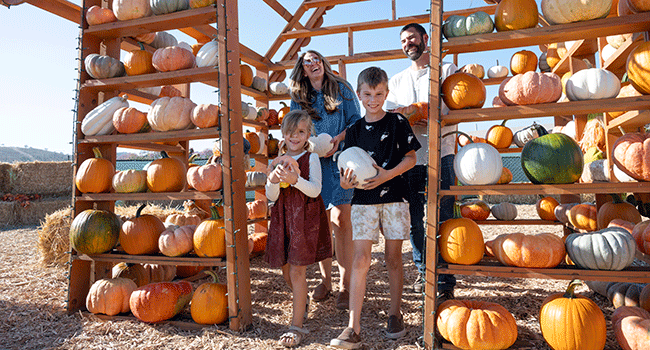 Talia holds a pumpkin during the 2023 Pumpkin Fest.