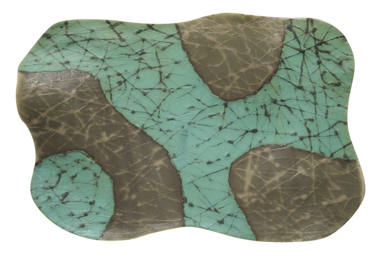 An abstract ceramic piece with an undulating shape, featuring a green surface interwoven with black crackling and irregular brown patches, creating a visually textured and organic pattern.