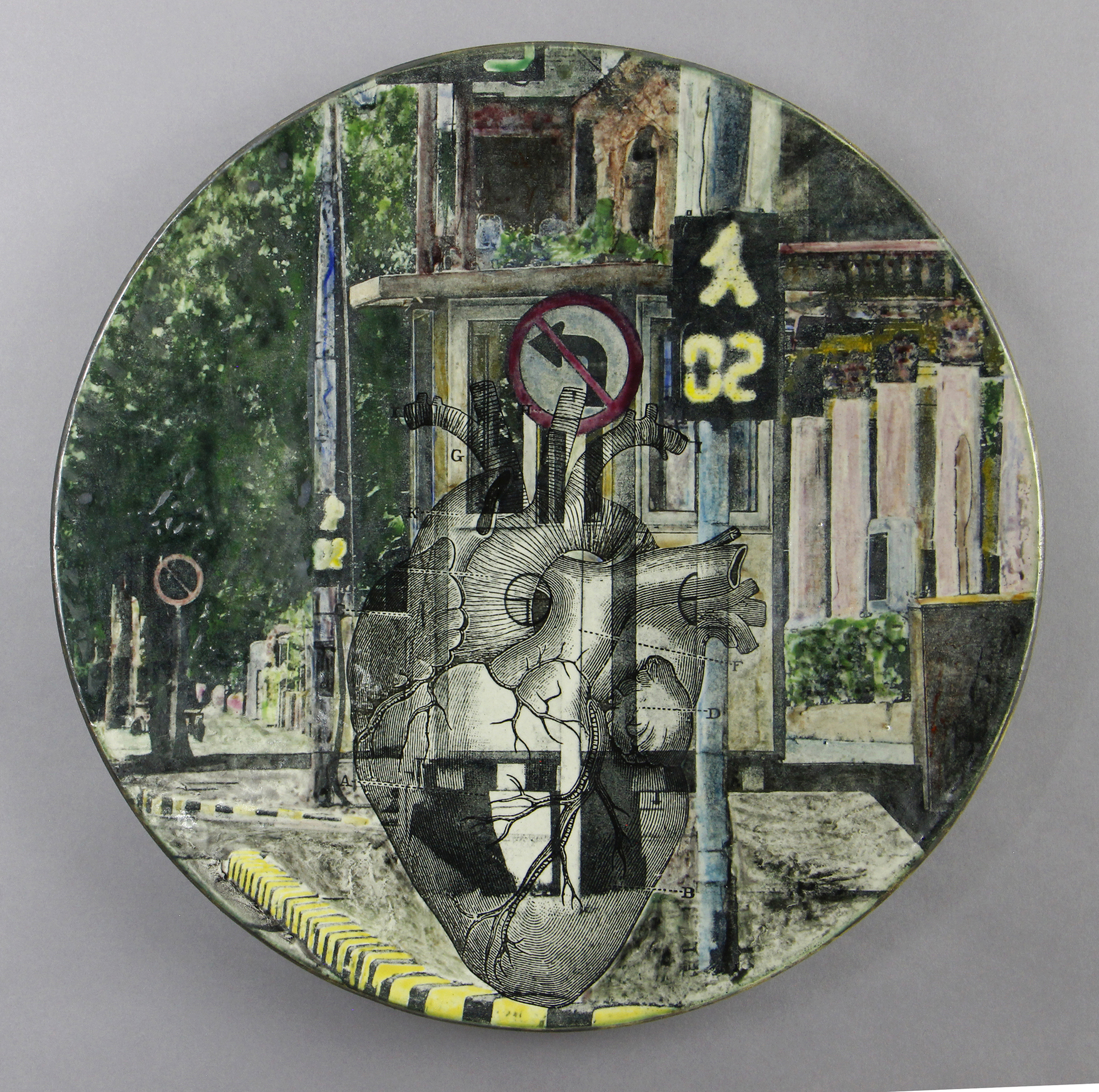 A circular artwork combining an anatomical heart illustration overlaying a city street scene with traffic signs, blending medical and urban elements.