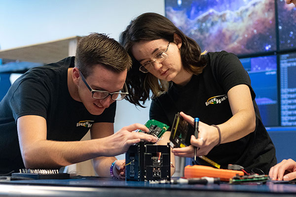 Two Bronco Space members work on Pleiades Rapid Orbital Verification Experimental System (PROVES)