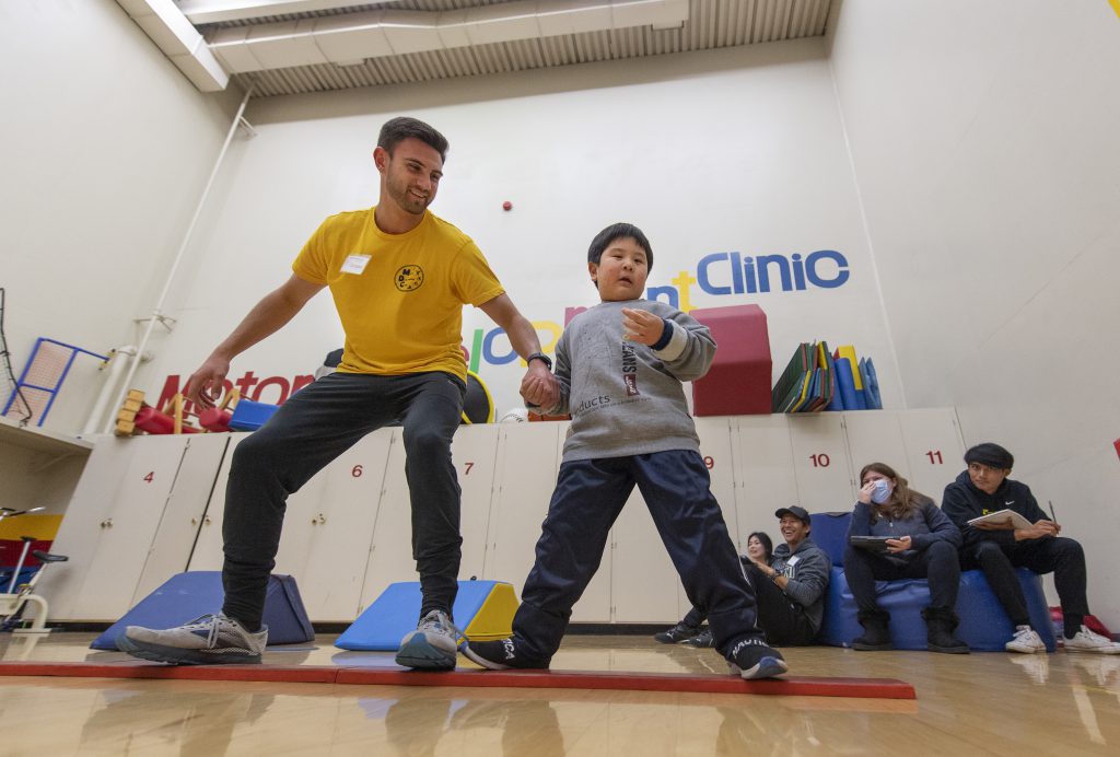 A child dances at the fine motor development clinic.