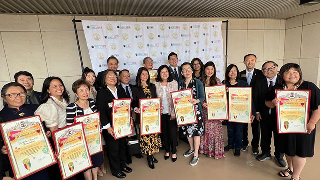 VP of Advancement (middle) poses for a photo with group receiving award.