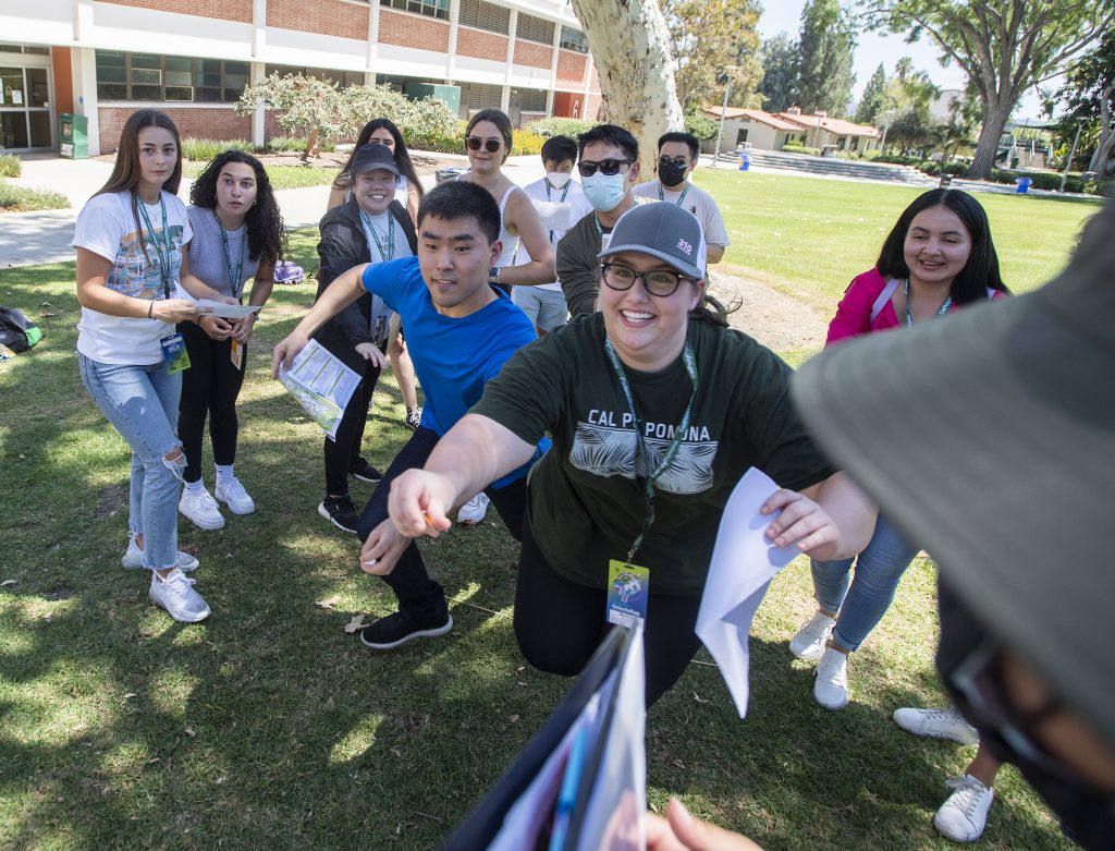 Orientation students race to a map of campus during an icebreaker in the quad.