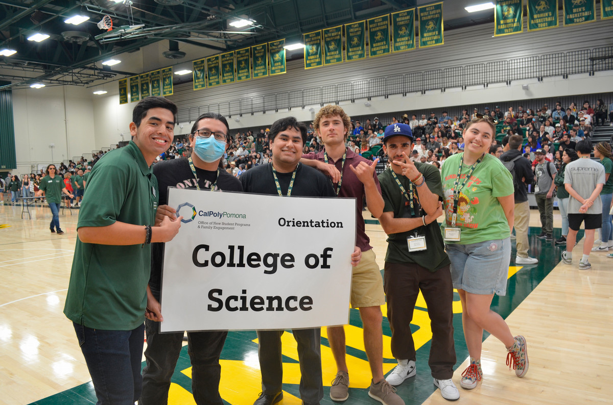 Students at orientation show off their college of science sign