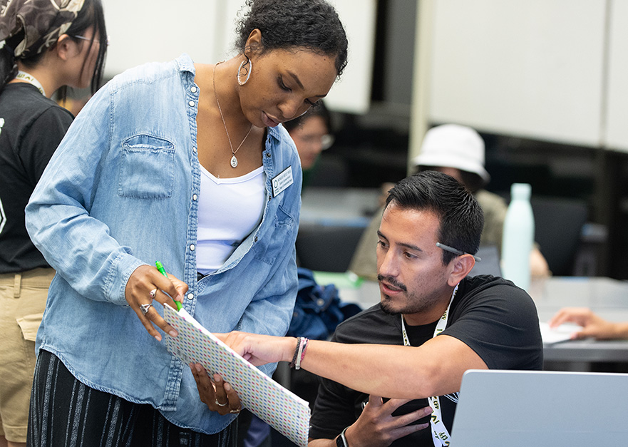 Female Counselor assists male student during orientation