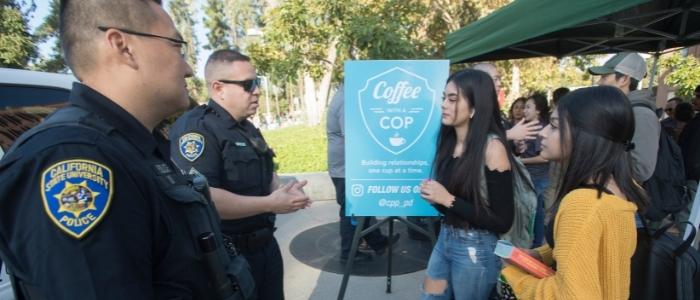 Students speak with police at a Coffee with a Cop event