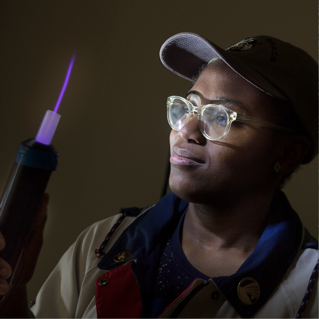 A student looks at a flame