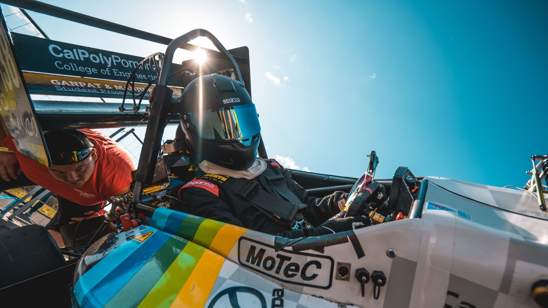 A Cal Poly Pomona engineering student in a formula race car.